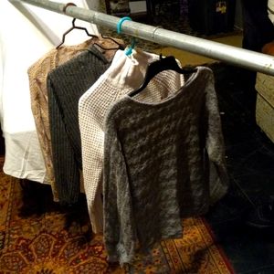 Women's sweaters ranging from light grey to dark grey and tan to white.